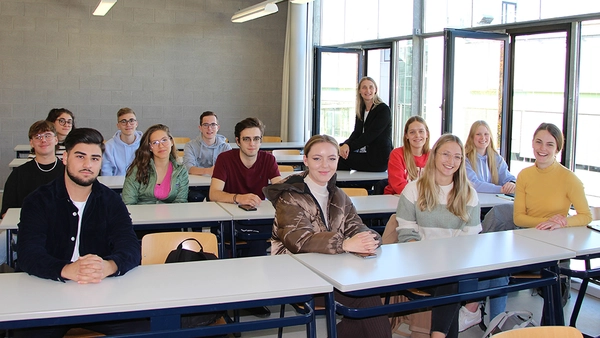 Prof. Schmidt sitting in a crowd of about 15 students