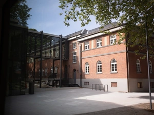 Der Campus Neuburg von Außen. Zu sehen ist ein Gebäude und der Glasübergang.